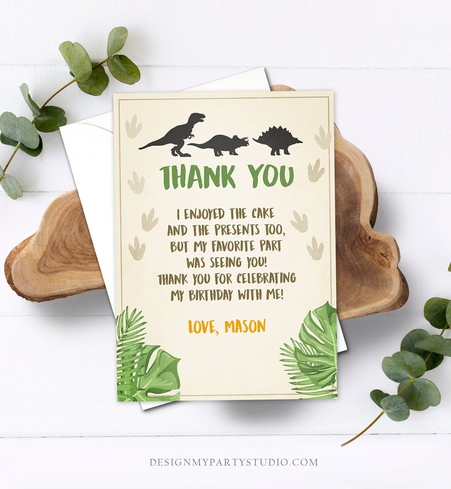 May include: A dinosaur themed thank you card with green leaves and brown footprints. The text reads: 'Thank You', 'I enjoyed the cake and the presents too, but my favorite part was seeing you! Thank you for celebrating my birthday with me! Love, Mason'.