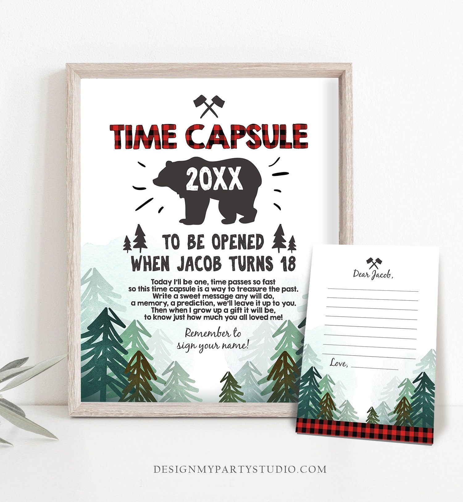 May include: A printable time capsule card with a red and black buffalo plaid pattern. The card features a black silhouette of a bear with the text 'Time Capsule 20XX' above it. The card also features the text 'To be opened when Jacob turns 18.' and a message about writing a memory or prediction for Jacob to read when he turns 18. The card includes a separate section for writing a message to Jacob.