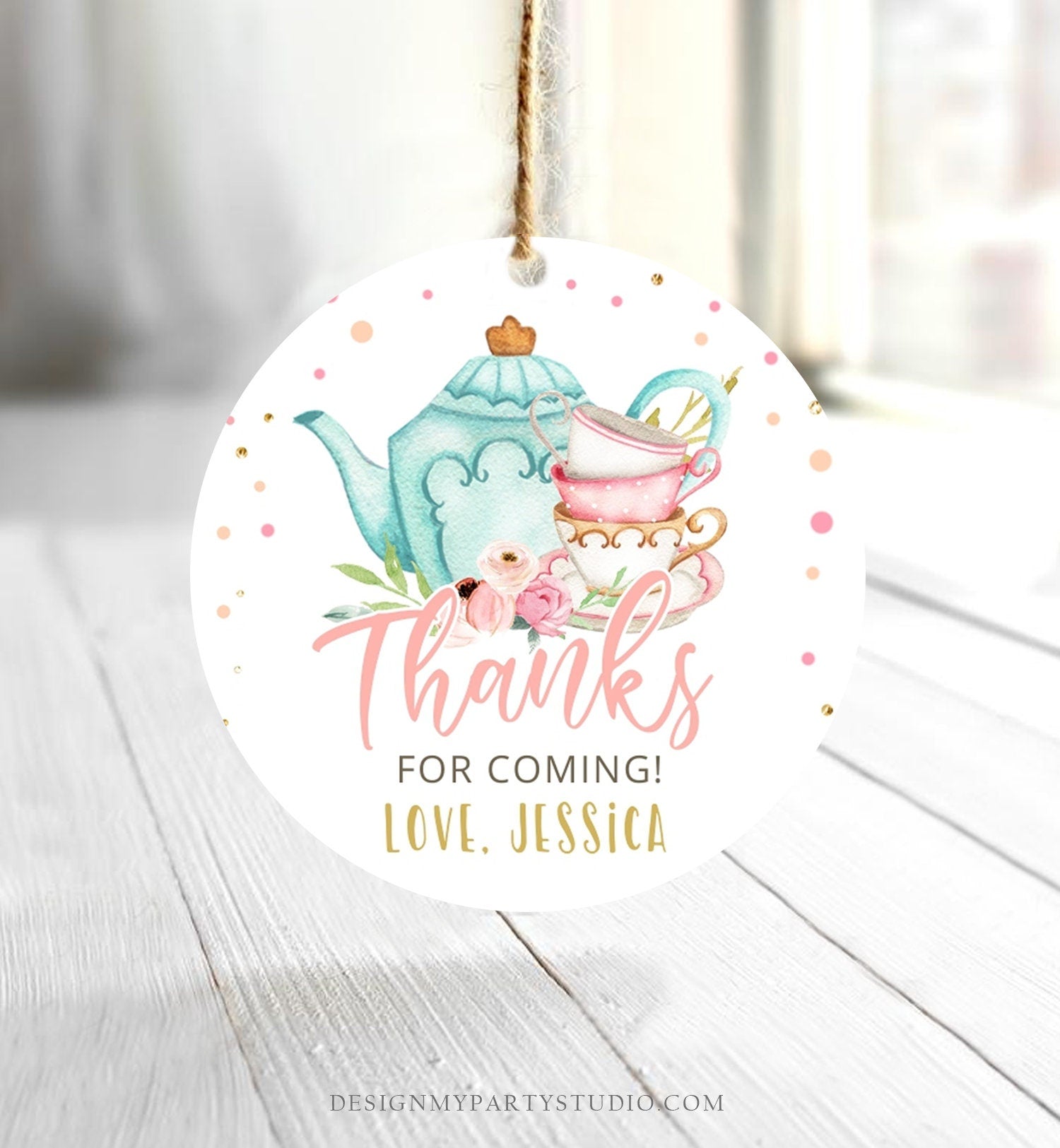 May include: Round white thank you tag with a blue teapot, pink and white teacups, and pink flowers. The tag has gold glitter and the text 'Thanks for coming! Love, Jessica'.