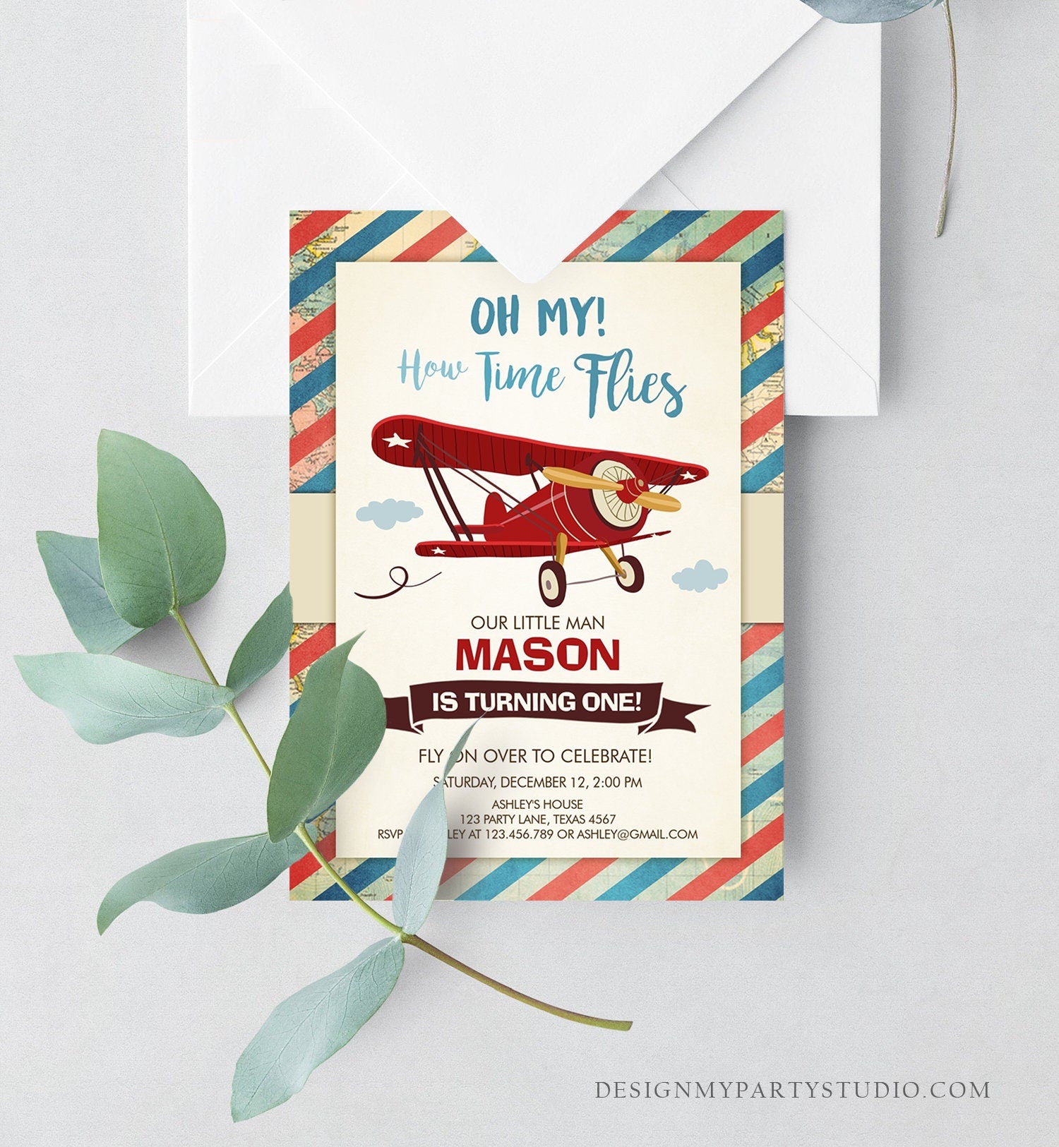 May include: A red and blue striped invitation with a red airplane flying in the clouds. The invitation reads &#39;Oh My! How Time Flies&#39;, &#39;Our Little Man Mason Is Turning One!&#39;, &#39;Fly On Over To Celebrate! Saturday, December 12, 2:00 PM&#39;, &#39;Ashley&#39;s House 123 Party Lane, Texas 4567&#39;, &#39;RSVP to Ashley at 123.456.789 or ashley@gmail.com&#39; and &#39;DesignMyPartyStudio.com&#39;.