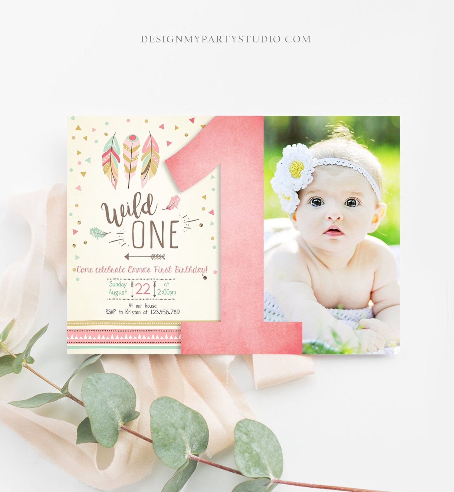 May include: A pink and green first birthday invitation with a photo of a baby girl. The invitation has a pink number one, feathers, and the text &#39;Wild One.&#39; The text also includes the date, time, and RSVP information.