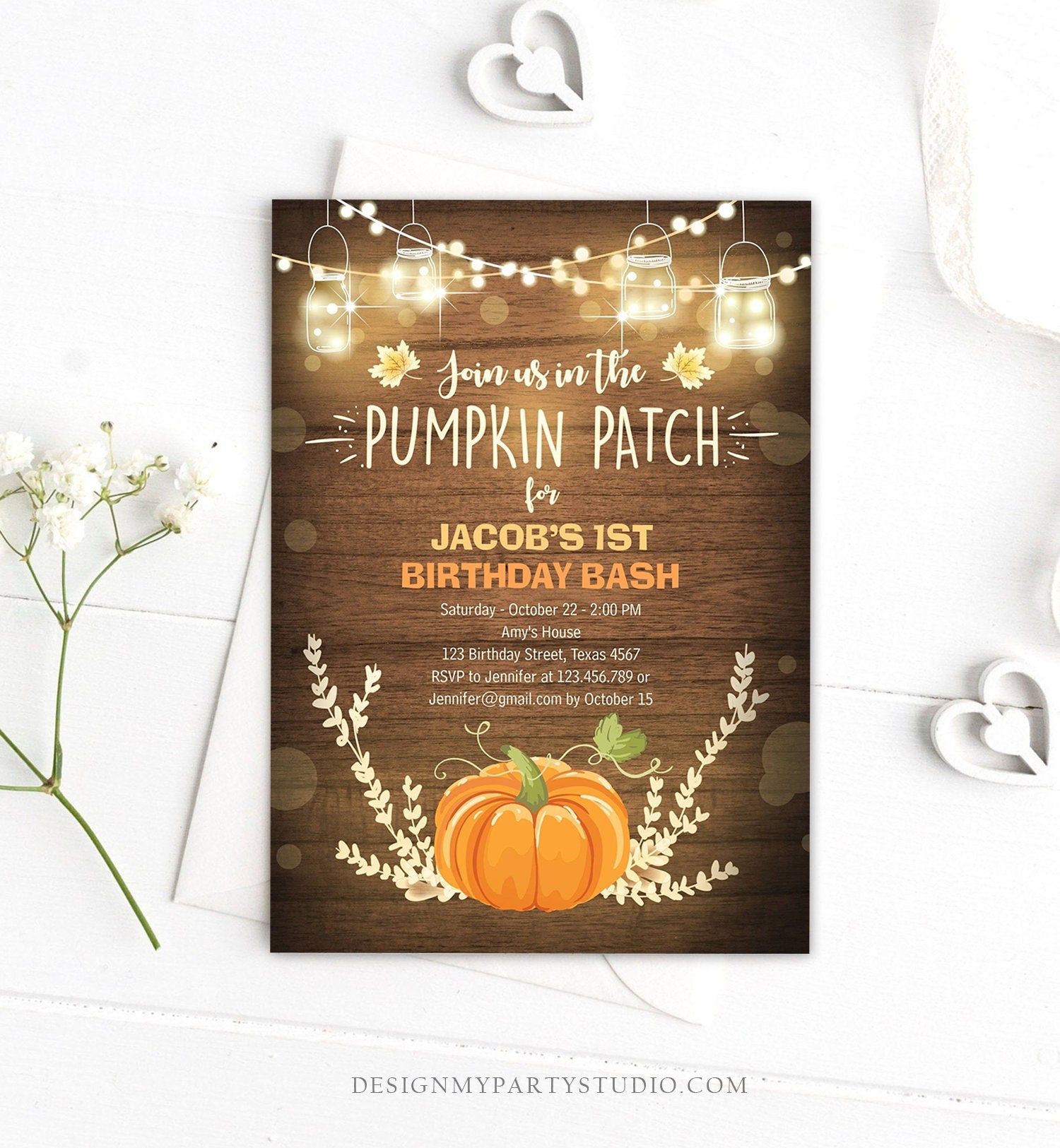 May include: A rustic wood background with a pumpkin patch birthday party invitation. The invitation is for Jacob&#39;s 1st birthday bash. The invitation has a pumpkin, fall leaves, and string lights. The text on the invitation reads: &#39;Join us in the Pumpkin Patch for Jacob&#39;s 1st Birthday Bash&#39;, &#39;Saturday - October 22 - 2:00 PM&#39;, &#39;Amy&#39;s House&#39;, &#39;123 Birthday Street, Texas 4567&#39;, &#39;RSVP to Jennifer at 123.456.789 or Jennifer@gmail.com by October 15&#39;,