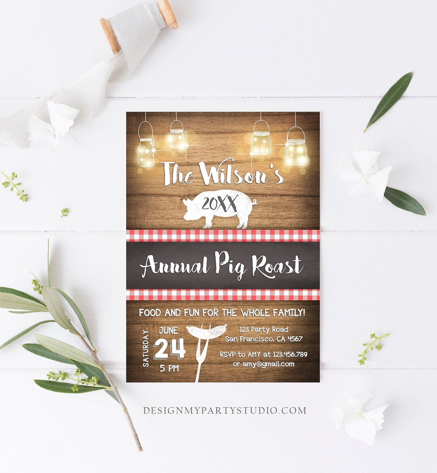 May include: A rustic wood background with a red and white checkered pattern and a white pig illustration. The text reads &#39;The Wilson&#39;s 20XX Annual Pig Roast&#39;. The invitation includes details for a party on June 24th at 5 PM, including the address, RSVP information, and the website &#39;DESIGNMYPARTYSTUDIO.COM&#39;.