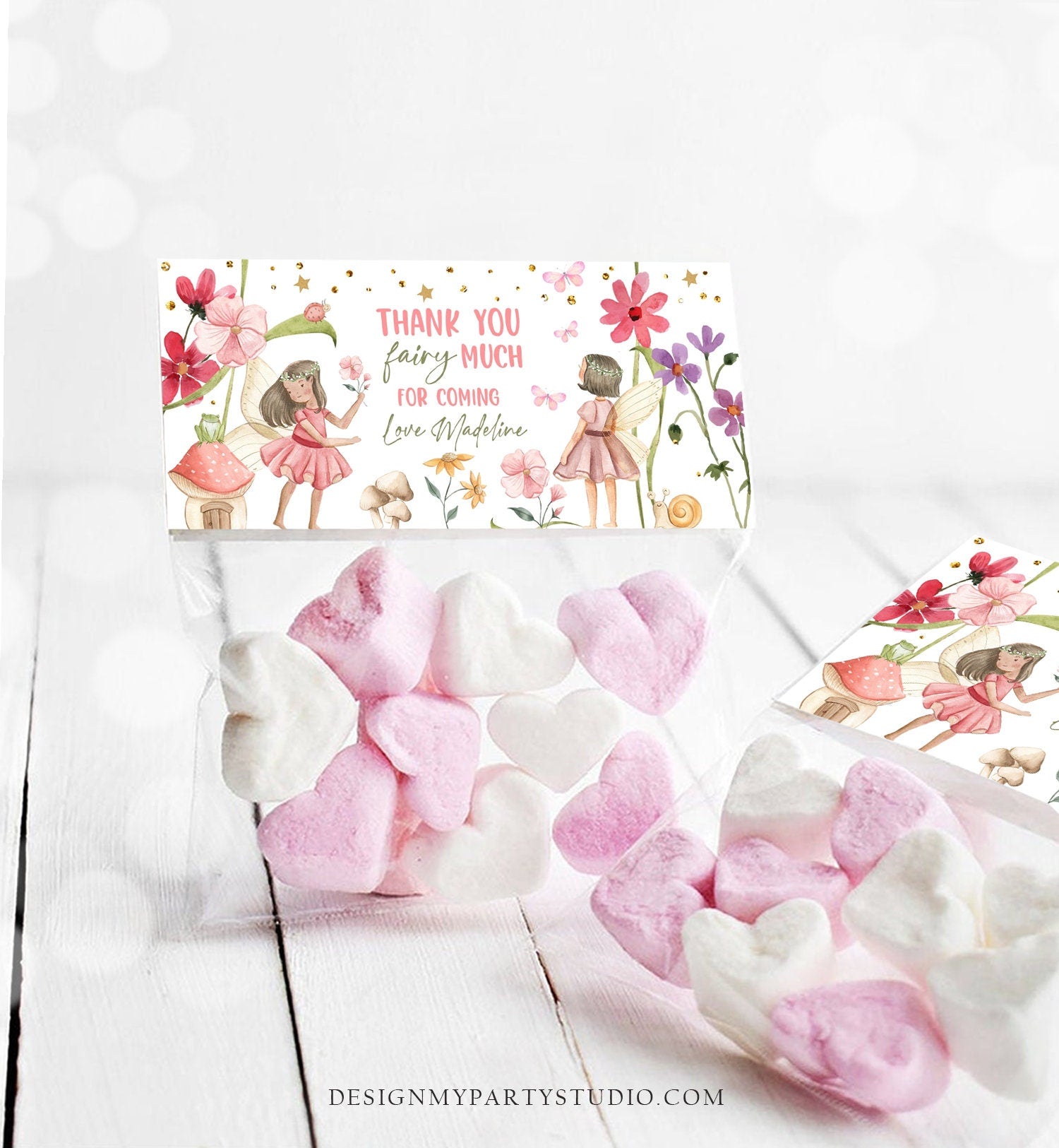 May include: A pink and green fairy themed thank you tag with gold glitter accents. The tag reads &#39;Thank you fairy much for coming Love Madeline&#39;. The tag features two fairies with wings, flowers, mushrooms, and a snail.
