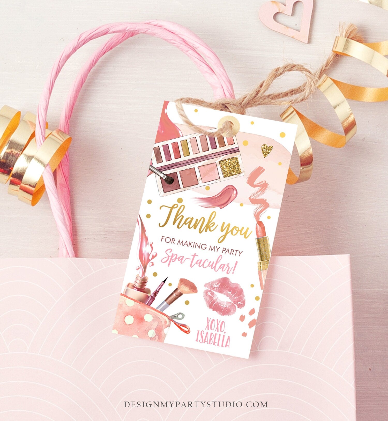 May include: A pink and gold thank you tag with a makeup theme. The tag features a pink and gold eyeshadow palette, lipstick, makeup brushes, and a pink and white polka dot makeup bag. The text on the tag reads &#39;Thank you for making my party Spa-tacular! XOXO. Isabella.&#39;