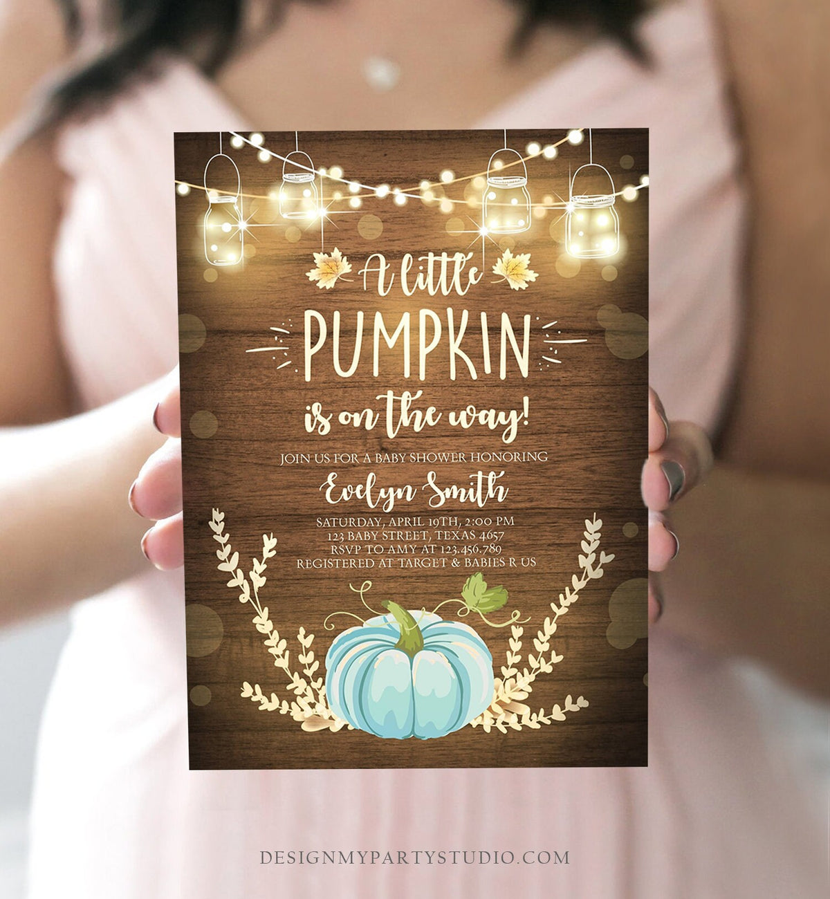 May include: A baby shower invitation with a rustic wood background and a blue pumpkin. The invitation reads &amp;#39;A little pumpkin is on the way!&amp;#39; and includes the name &amp;#39;Evelyn Smith&amp;#39;, the date and time of the shower, the address, and RSVP information. The invitation also includes the text &amp;#39;Registered at Target &amp; Babies R Us&amp;#39;.