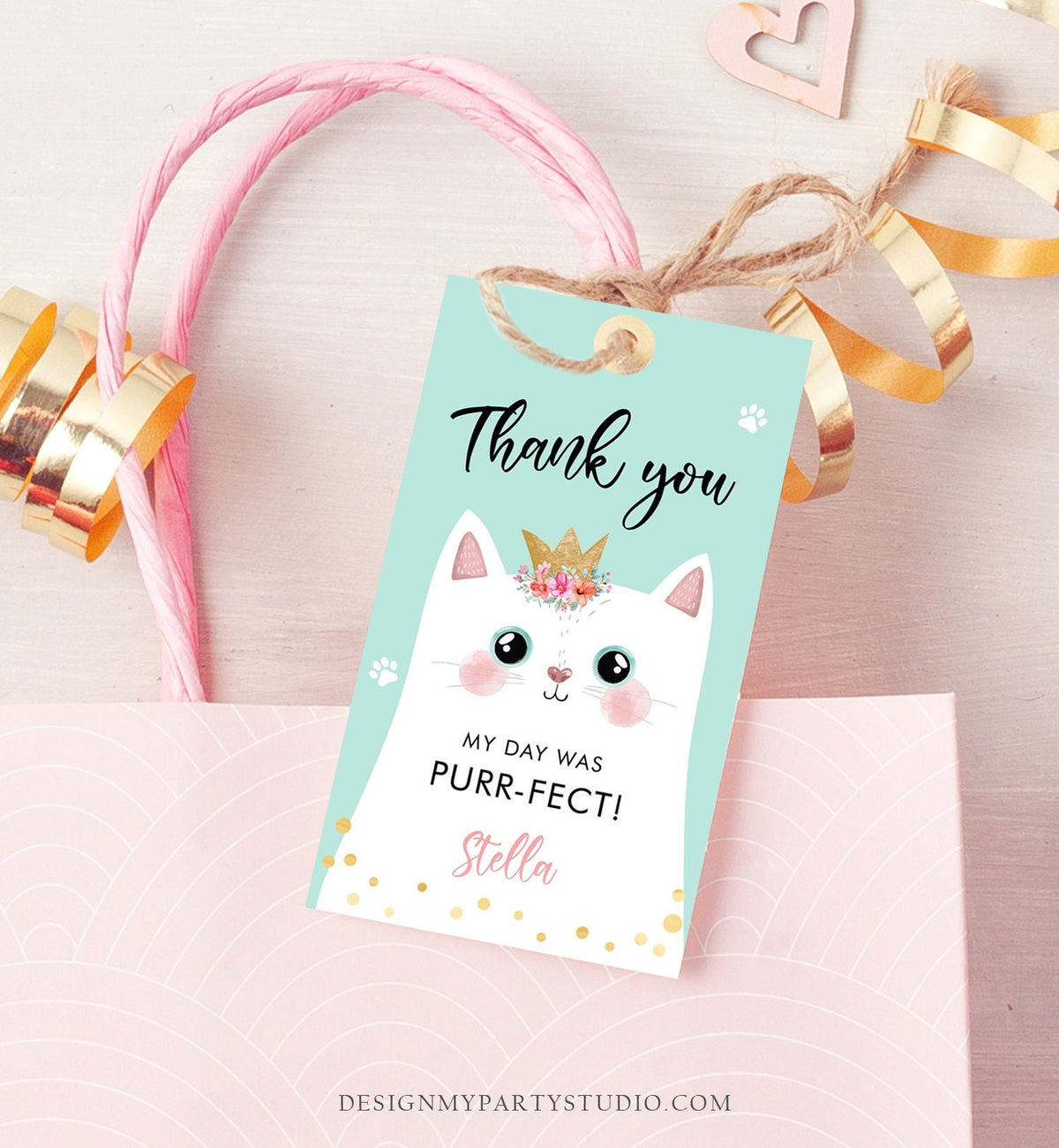 May include: A turquoise thank you tag with a white cat wearing a gold crown and a pink flower crown. The text on the tag reads &amp;#39;Thank you&amp;#39;, &amp;#39;My day was purr-fect!&amp;#39; and &amp;#39;Stella&amp;#39;. The tag is decorated with gold glitter and paw prints.