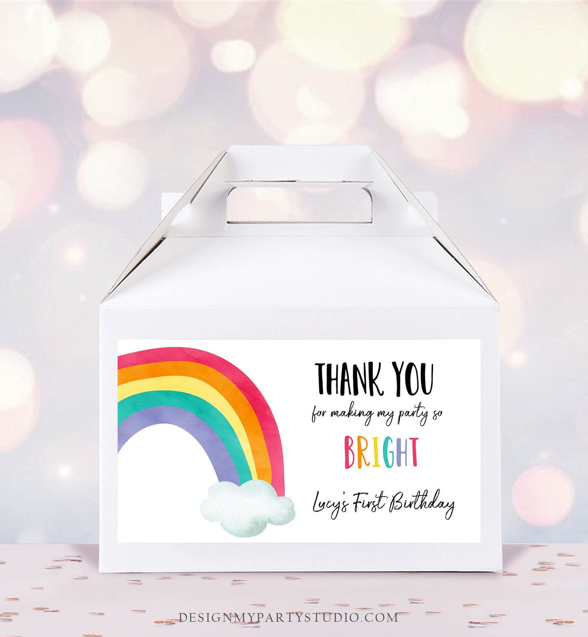 May include: A white favor box with a rainbow and cloud design and a thank you sticker that says &amp;#39;Thank you for making my party so bright Lucy&amp;#39;s First Birthday&amp;#39;.