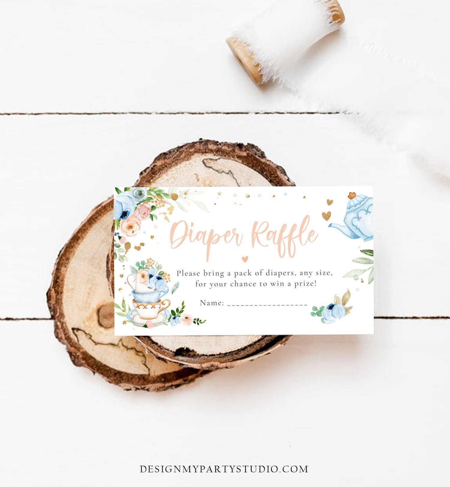 May include: A white card with blue and pink floral designs and gold accents. The text on the card reads 'Diaper Raffle' in pink text with a heart symbol. The text below reads 'Please bring a pack of diapers, any size, for your chance to win a prize!' and 'Name:' with a blank line for the name.