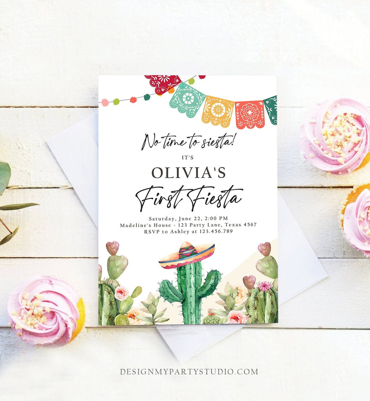 May include: A first birthday party invitation with a cactus theme. The invitation is white with a green cactus wearing a sombrero. The text reads &amp;#39;No time to siesta! It&amp;#39;s Olivia&amp;#39;s First Fiesta. Saturday, June 22, 2:00 PM. Madeline&amp;#39;s House - 123 Party Lane, Texas 4567. RSVP to Ashley at 123.456.789. DESIGNMYPARTYSTUDIO.COM&amp;#39;