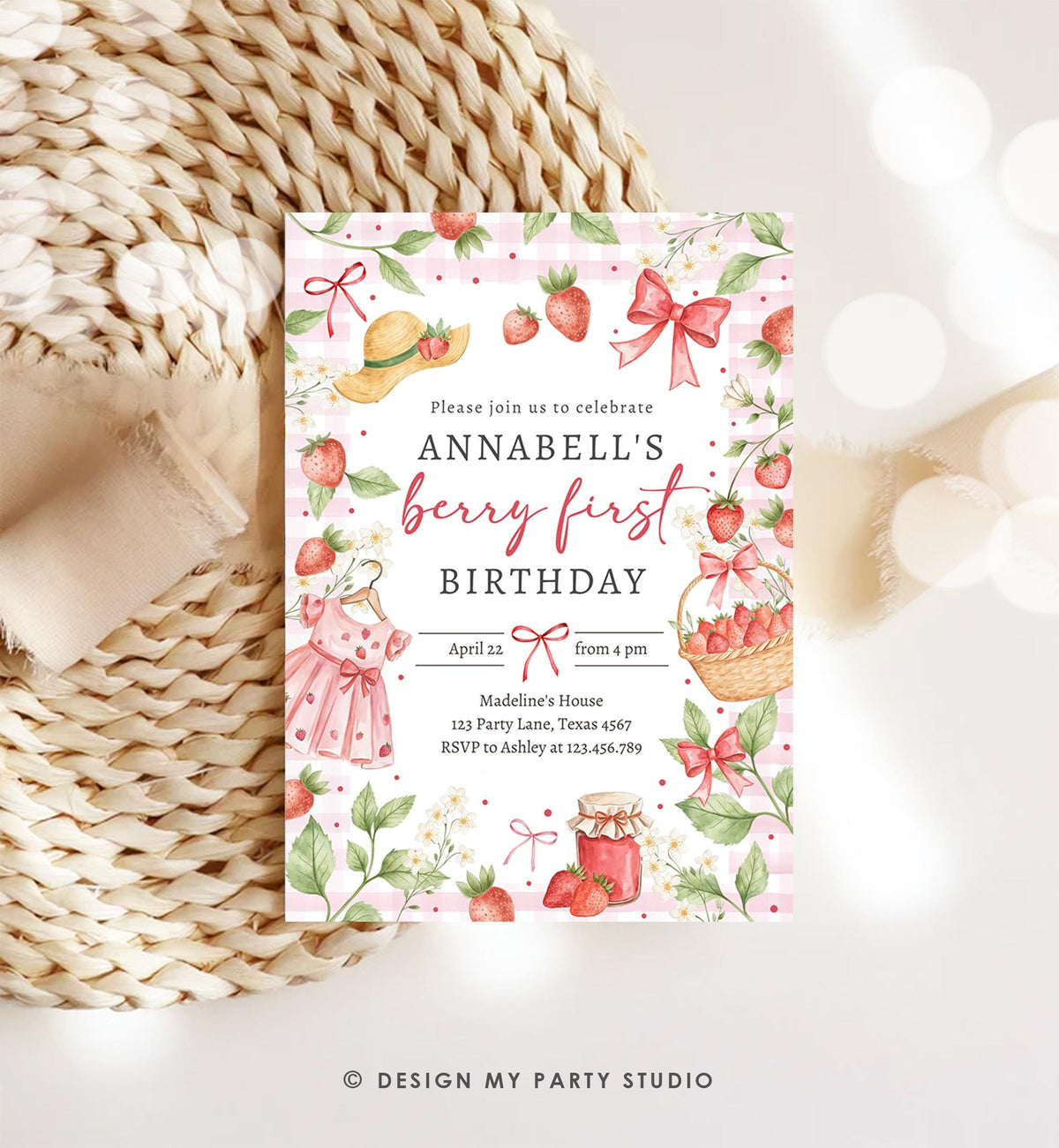May include: A strawberry-themed birthday invitation with the text &amp;quot;Annabell&amp;#39;s berry first birthday.&amp;quot; The invitation features illustrations of strawberries, a dress, a basket of strawberries, and a jar of jam. The background has a pink gingham pattern.