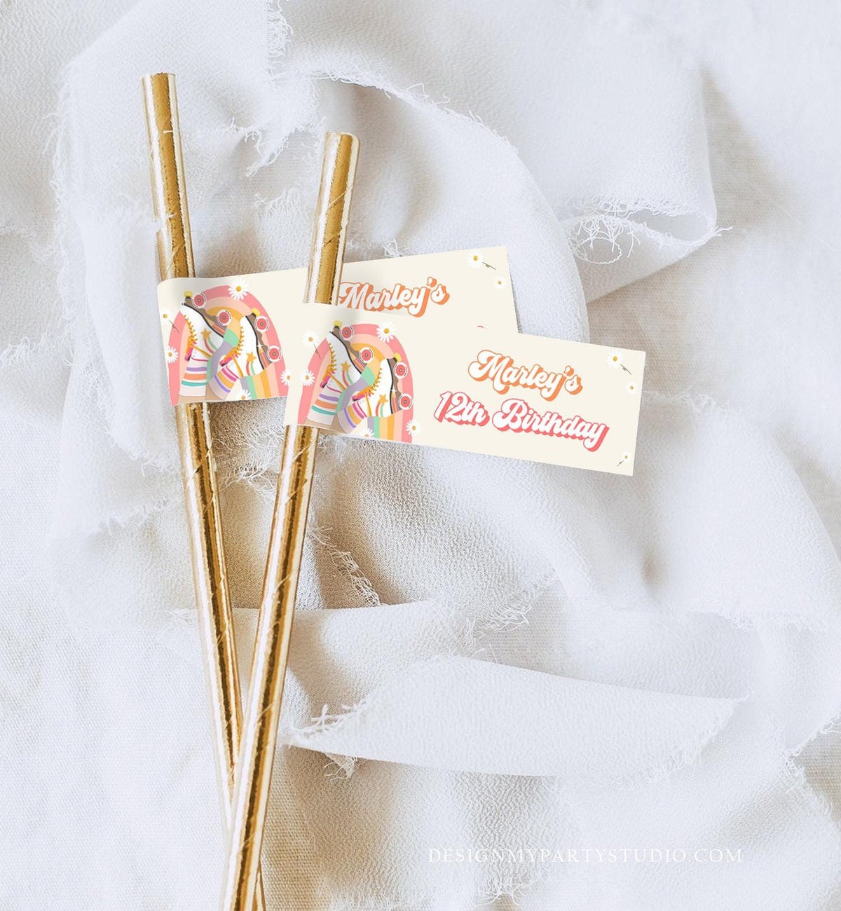 May include: Two gold paper straws with attached rectangular tags. The tags feature a retro rainbow design and the text &amp;quot;Marley&amp;#39;s 12th Birthday&amp;quot; in a vintage font. The background is a soft, off-white fabric.