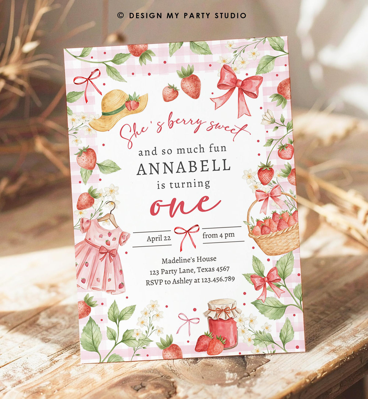 May include: A pink and white gingham birthday invitation with strawberry illustrations. The invitation includes text that reads &amp;quot;She&amp;#39;s berry sweet and so much fun, Annabell is turning one.&amp;quot; Additional details include the date, time, and RSVP information.